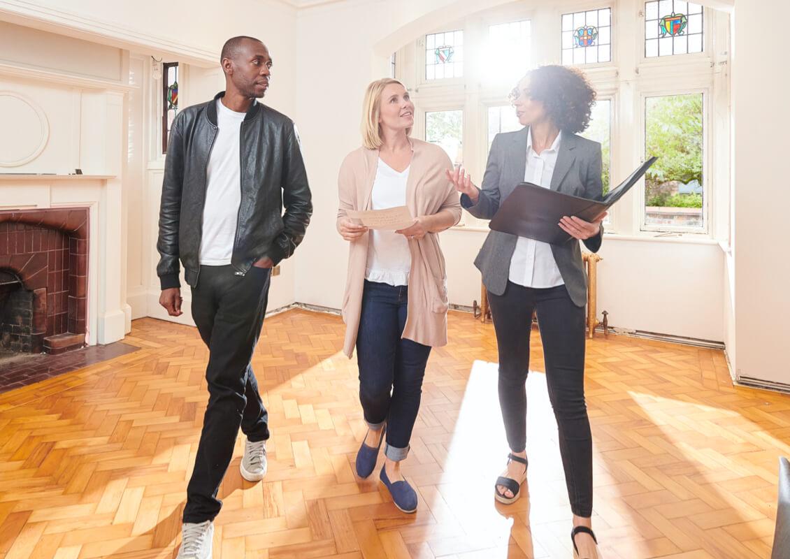 couple viewing house with real estate agent